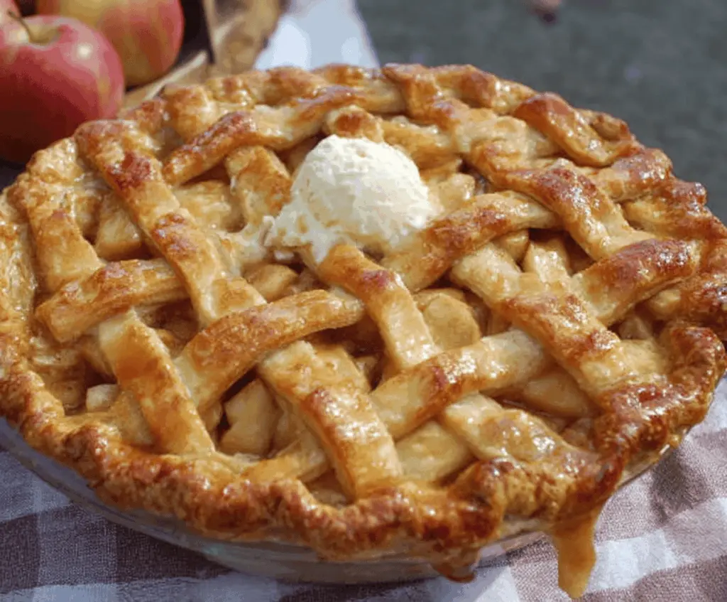 Delicious homemade apple pie by Grandma Ople with golden crust and cinnamon-spiced apple filling, perfect for dessert or family gatherings.