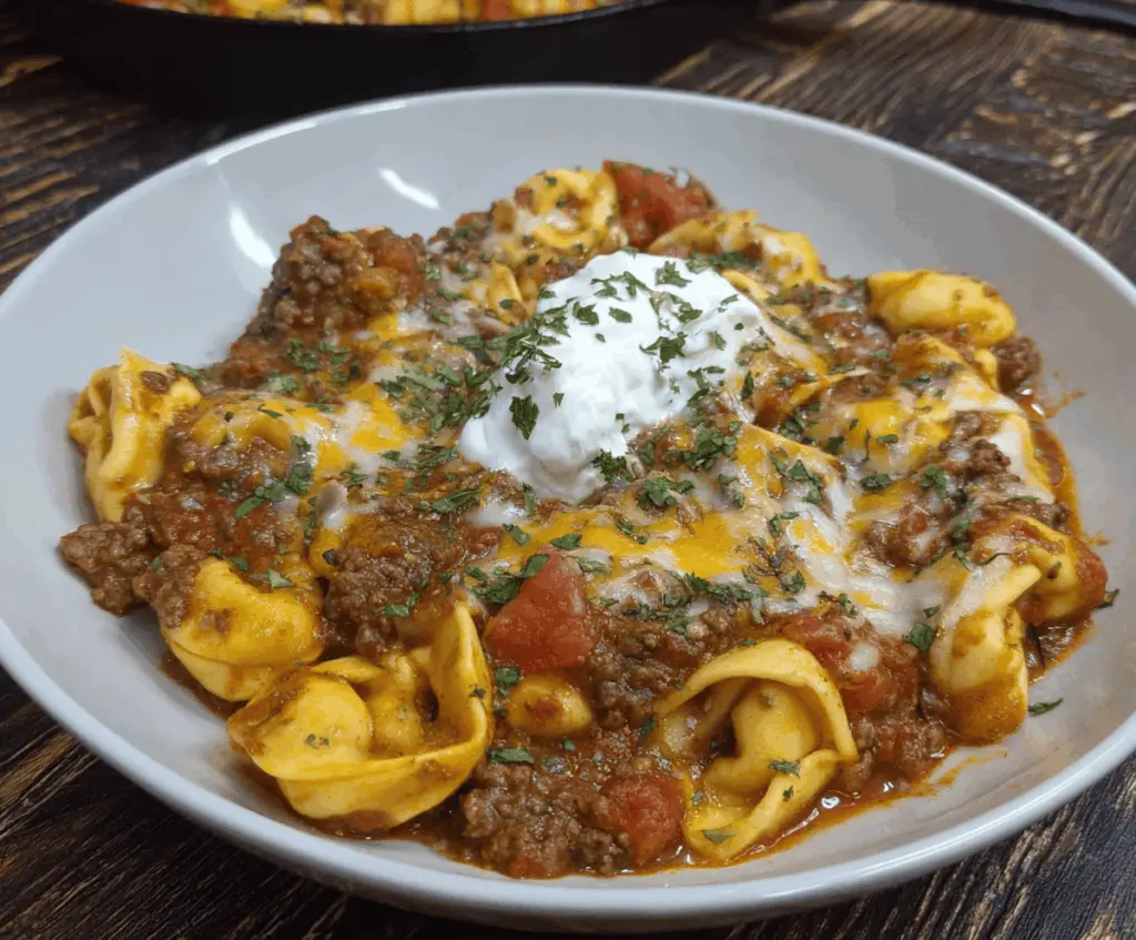 Delicious Beef Enchilada Tortellini served with melted cheese and fresh herbs on a plate