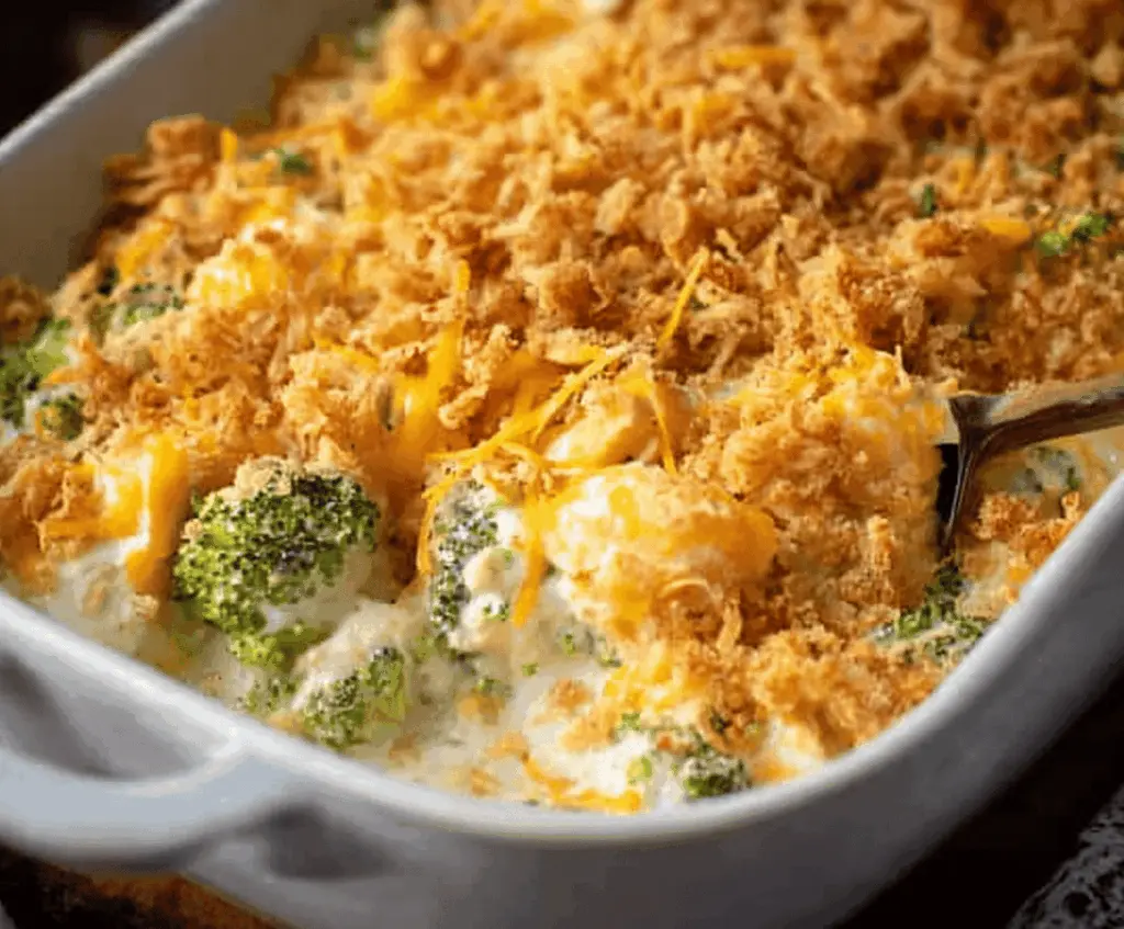 Creamy chicken divan casserole with broccoli and cheese in a baking dish