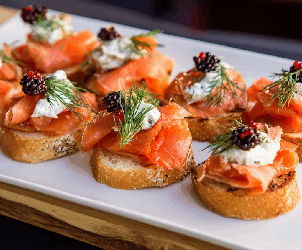 Delicious smoked salmon appetizer served with fresh herbs and lemon slices.