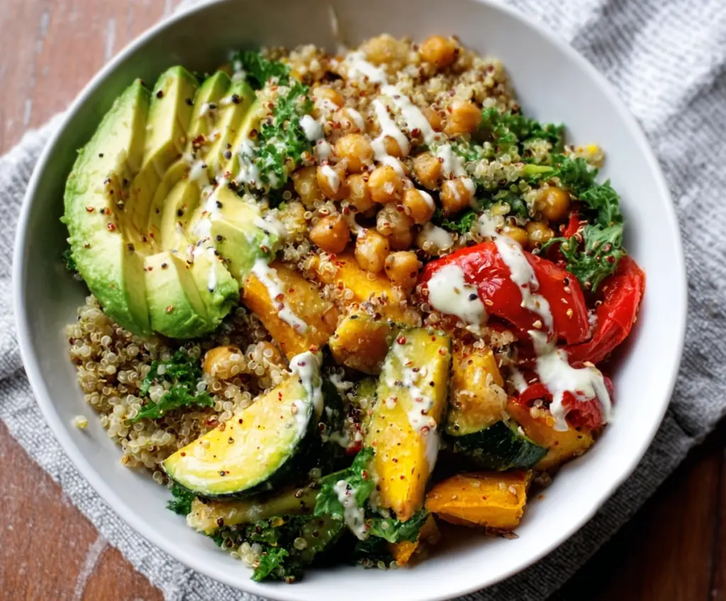 Healthy clean eating quinoa veggie bowl with colorful fresh vegetables and grains.