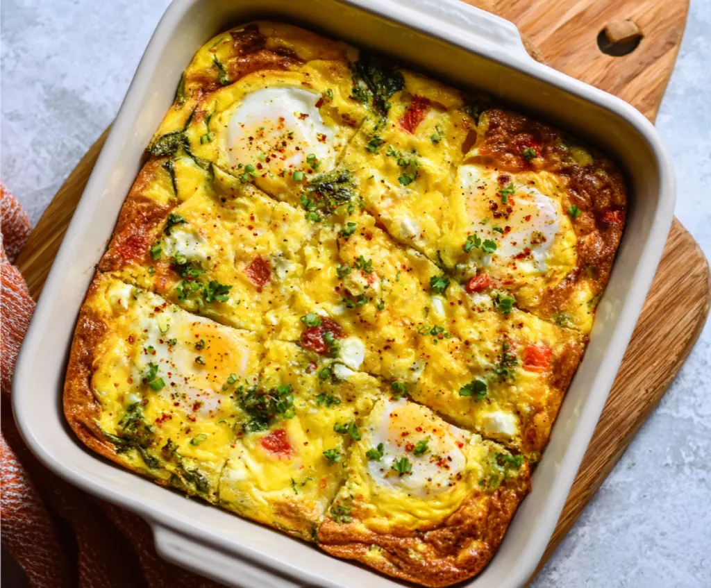 Delicious cottage cheese egg bake with fresh herbs and melted cheese on top.