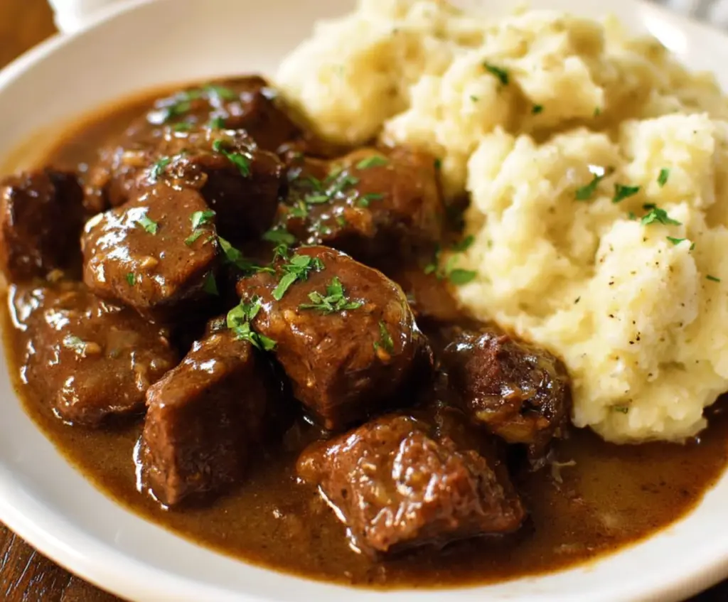 Delicious beef tips smothered in savory gravy served with mashed potatoes.